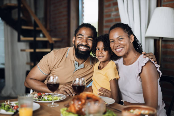 istock Happy black family enjoying during lunch at dining table 1704515659