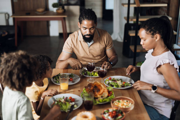 istock Young black family having Thanksgiving meal at dining table 1704517093