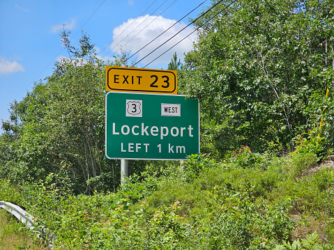 Sable, NS, CAN, 7.25.2023 - A sign for the town off Lockeport stationed in the bushes.