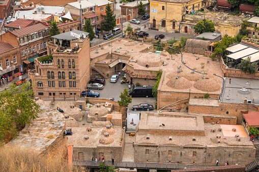 Georgia, Tbilisi - 30 August 2019: Historical buildings in the Old Town of Tbilisi. Capital City. Domed brick roofs of underground baths.