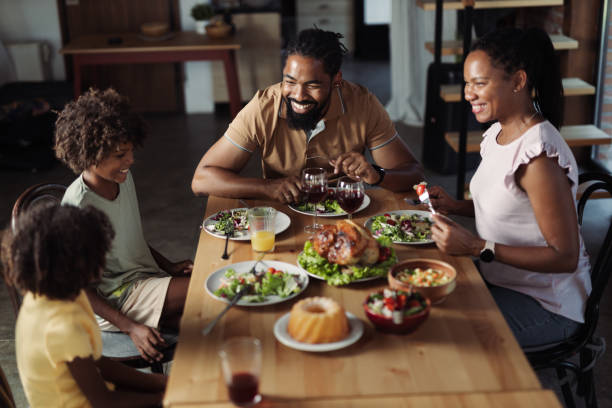 istock Young black family talking during Thanksgiving meal at dining table 1704527053