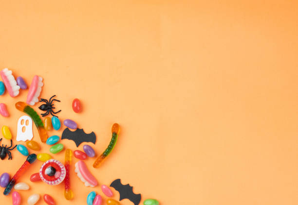 istock Colorful candies over orange background with copy space 1704528136