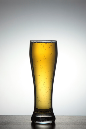 Front view of tall glass full of beer
