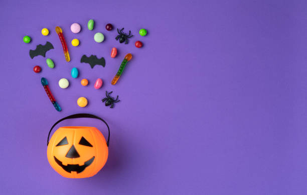 istock Assorted colorful candies over purple background with copy space 1704528719