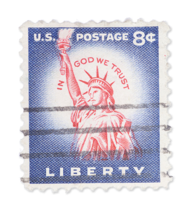Vintage US stamp with Statue of Liberty picture. Isolated on white with light shadow. Canon 5D Mark II.