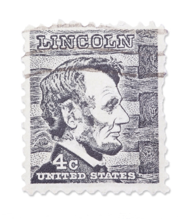 Vintage US stamp with Abraham Lincoln portrait portrait. Isolated on white with light shadow. Canon 5D Mark II.