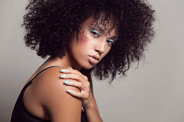 Attractive beauty Portrait of a young mixed race woman woman with natural curly hair. eyeshadow photos stock pictures, royalty-free photos & images