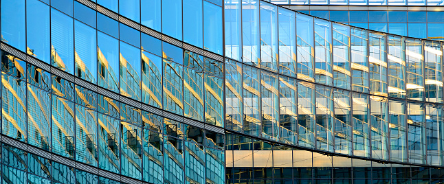 Low angle view of modern building with glass facade against clear sky, Berlin Charlottenburg