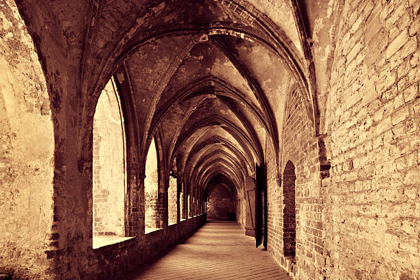 Vilar de Donas monastery church beautifully restored doorway portico seen through cloister stone arcade, Palas de Rei, Lugo province, Galicia, Spain. Camino de Santiago, camino francés.
