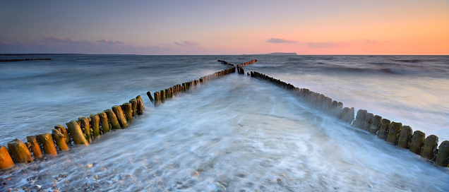 The North Sea tide rushing out at the South breakwater pier in Torry, Aberdeen, Scotland.