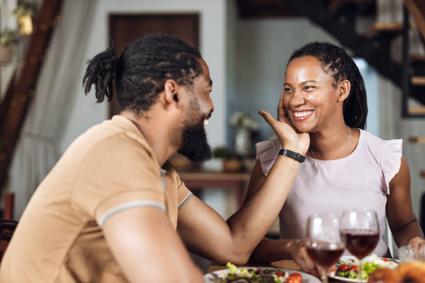 istock Happy African American couple  talking during lunch at dining table 1704534098