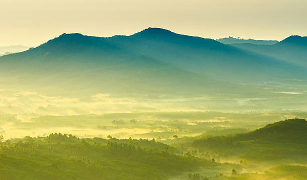 Beautiful sunrise at misty morning mountains .