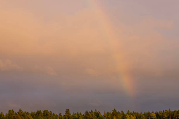 Beautiful view of stormy sky with rainbow during rain.