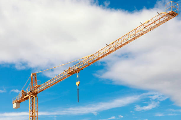 View of yellow crane, clear blue sky in background