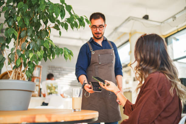 istock Mobile payment with phone at coffee shop. 1704551180