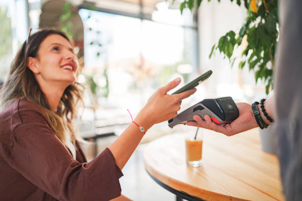 istock Mobile payment with phone at coffee shop. 1704555013