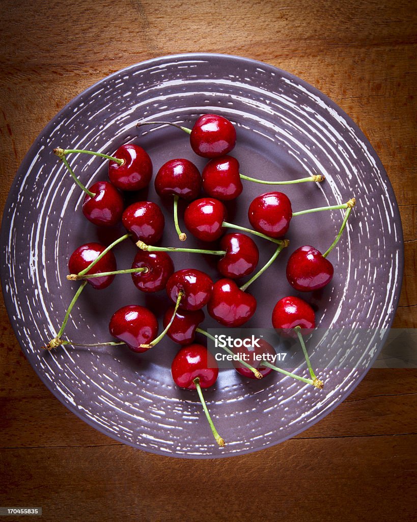cherry plate plate with cherry on grey background  Above Stock Photo