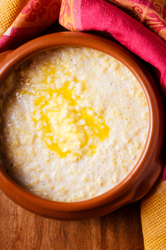 millet porridge with melted butter in ceramic pot - traditional russian food - kasha
