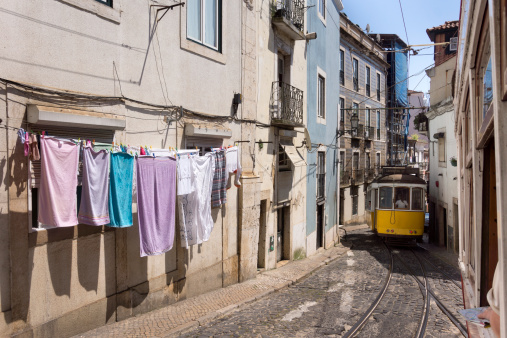 Trams passing through the narrow streets of Alfama in Lisabon, Portugal.