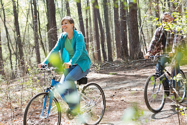 istock Active couple riding bikes together on wooded park trails 170456228