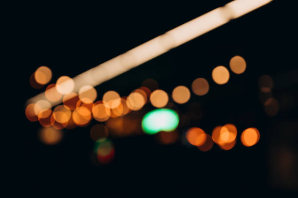 istock Decorative string lights at night time, Defocused Background, night city life backdrop, party time with Yellow bokeh balls. Warm festive bokeh of string lights over an outdoor bar or patio at twilight 1704566999