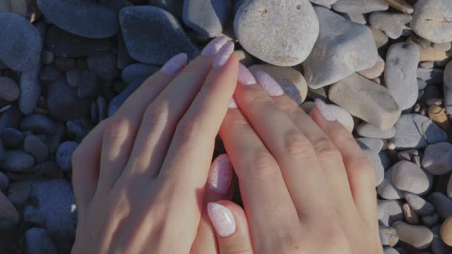 Female hands with beautiful natural pink elegant manicure.