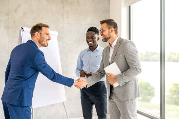 istock Two businesspeople shaking hands in an office 1704574528