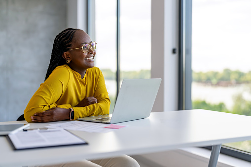 Attractive young businesswoman sitting alone in the office