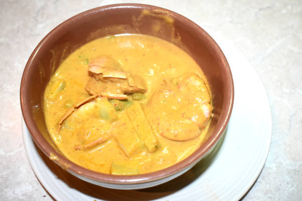 istock Thai tradition with Panang curry with King prawns in a bowl on white plate, Easy cooking at home with Thai food style. 1704585895