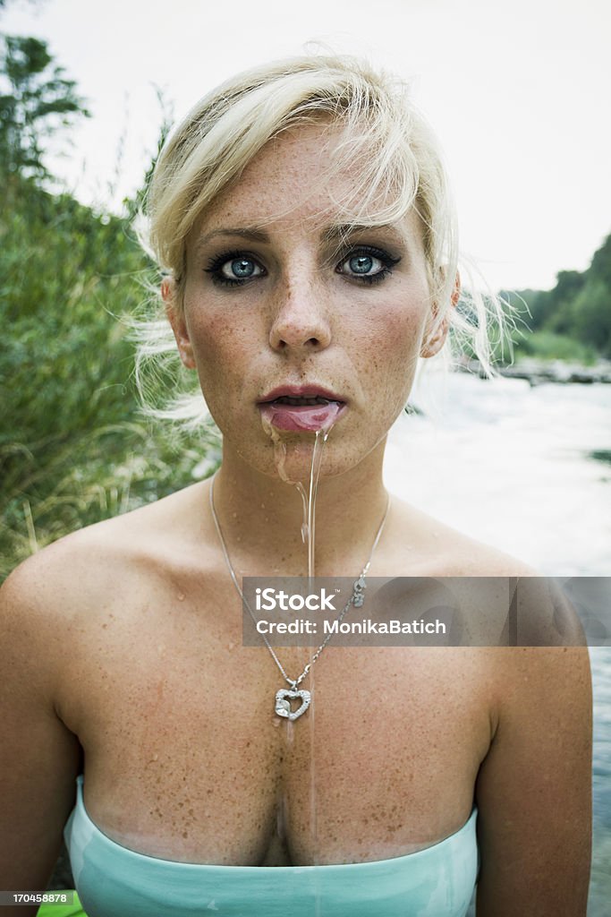 realy hot summer young blonde woman slobbering becouse of extremly hot weather by the river soča. natural sunlight is an intentional decision to preserve the simplicity of picture. Women Stock Photo