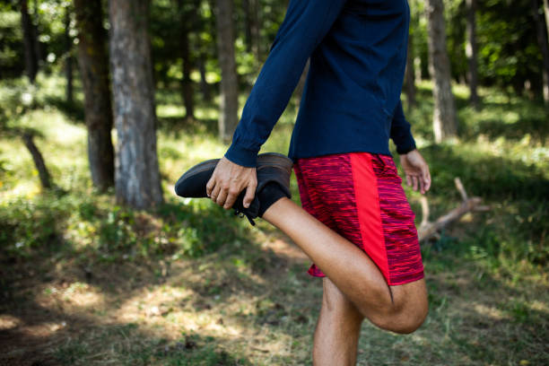 istock Man exercising outdoors. Man stretching his body before training. 1704589258