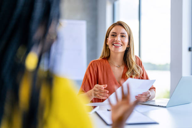 istock Businesswomen talking in the office 1704590321