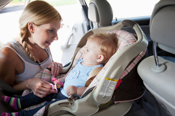 istock Mother with baby in car seat 170461022