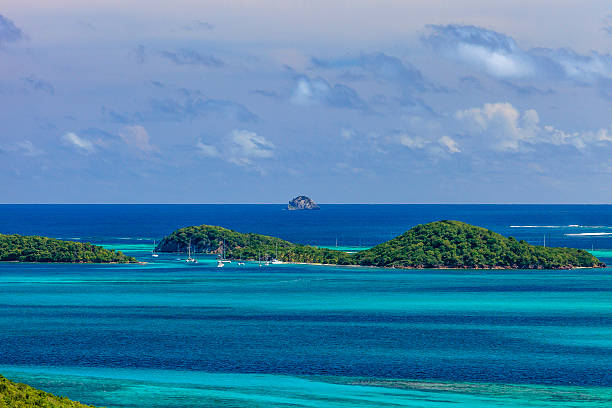 Tobago Cays The Tobago Cays surrounded by the beautiful blue and turquoise shades of the Caribbean Sea. Photo taken from Mayreau Island. St. Vincent and the Grenadines.  tobago cays stock pictures, royalty-free photos & images