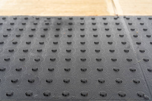 istock Close up image of a gray detectable warning surface, tactile plate at a ADA crosswalk curb ramp. 1704616497