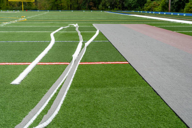istock Synthetic turf field under construction with lines and graphics being installed. 1704617561