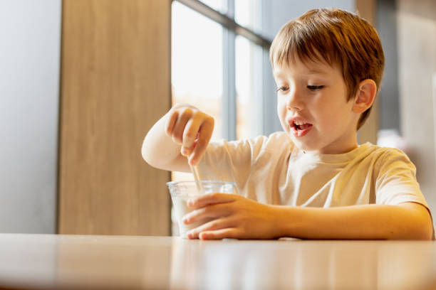 istock 6 year old boy eats ice cream in a cafe 1704624498