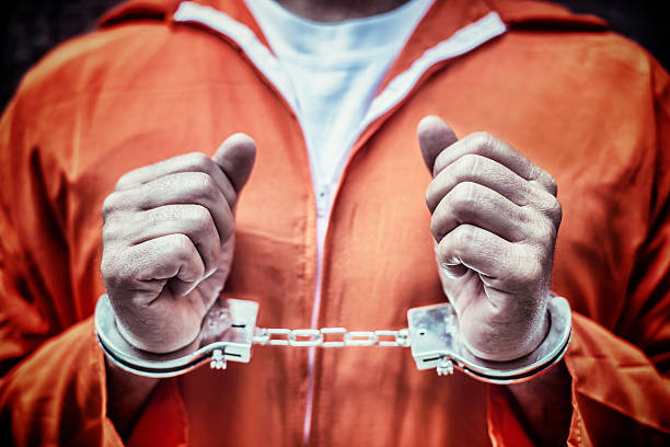 handcuffed prisionero en monos naranja - guantanamo bay fotografías e imágenes de stock