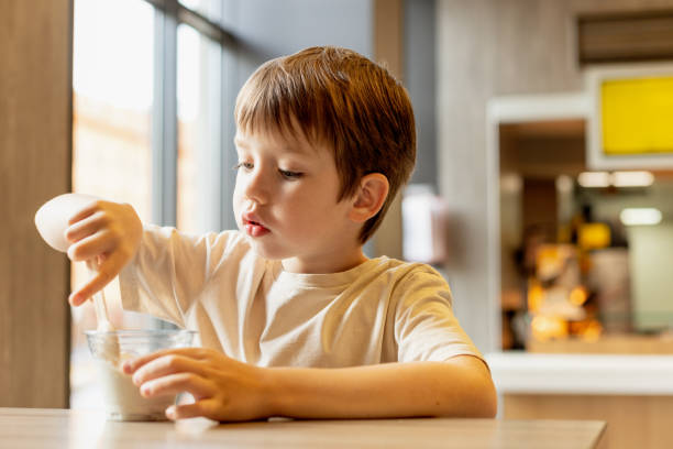 istock 6 year old boy eats ice cream in a cafe 1704624500