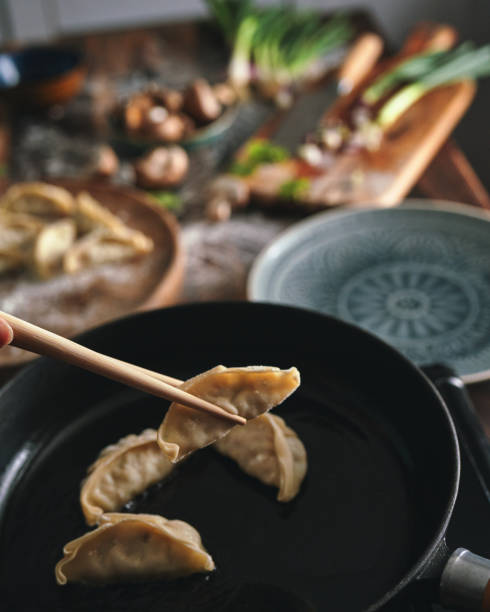 istock Preparing Gyoza in a Cooking Pan 1704628857