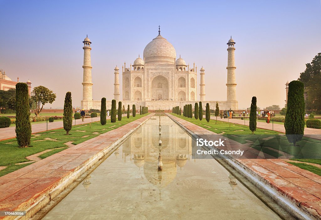 Taj Mahal sunrise with reflection Taj Mahal at sunrise, reflects in the pond. Agra Stock Photo