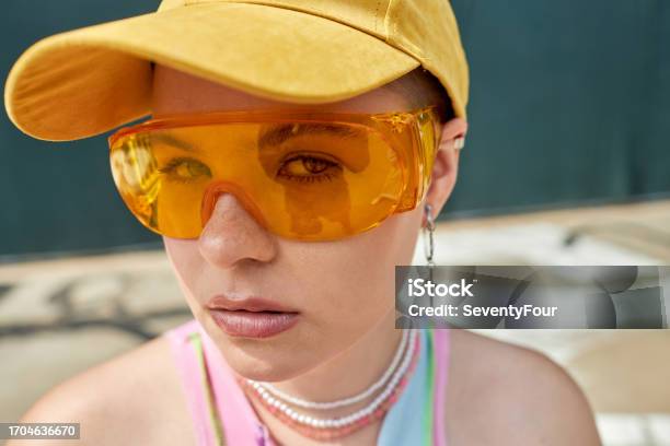Girl Looking At Camera With Yellow Sunglasses Stock Photo - Download Image Now - 20-24 Years, Adult, Adults Only
