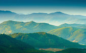 Beautiful sunrise at misty morning mountains .