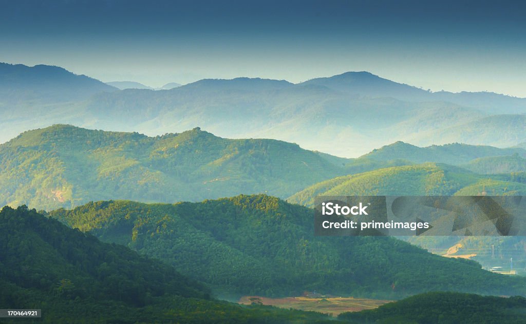 Beautiful sunrise at misty morning mountains . Green Color Stock Photo