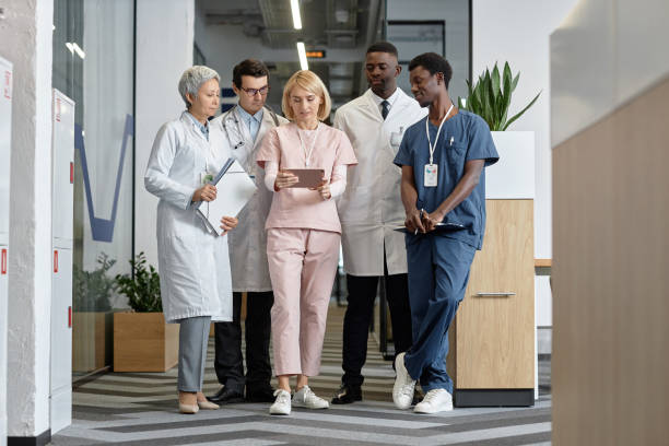istock Group of modern clinicians looking at tablet screen at working meeting 1704651186