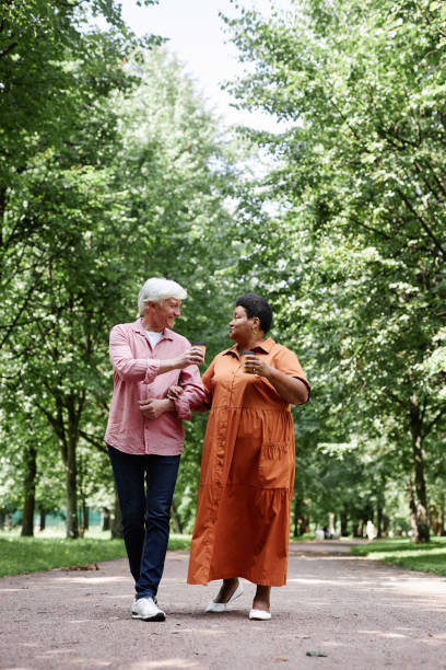 istock Happy senior couple walking on park path together and holding hands 1704660041
