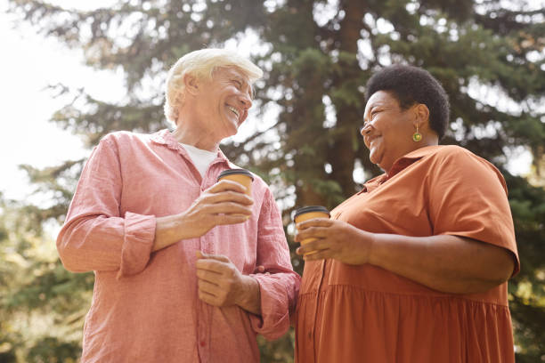 istock Low angle multiethnic senior couple enjoying date outdoors and laughing happily 1704660044