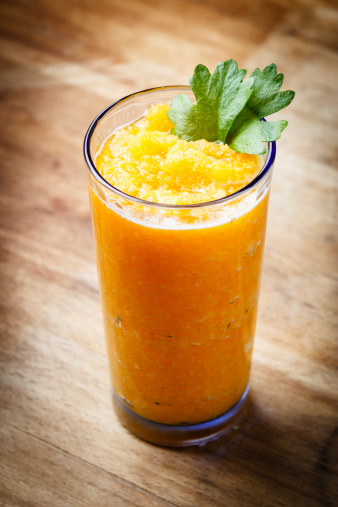 pumpkin smoothie with celery twig on old wood background