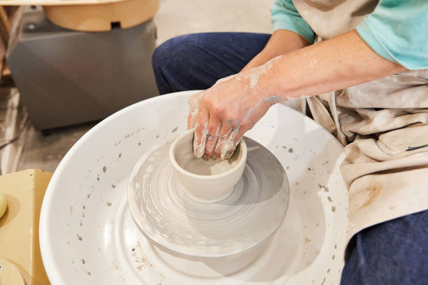 istock Unrecognizable artist making a clay bowl on a pottery wheel 1704678796