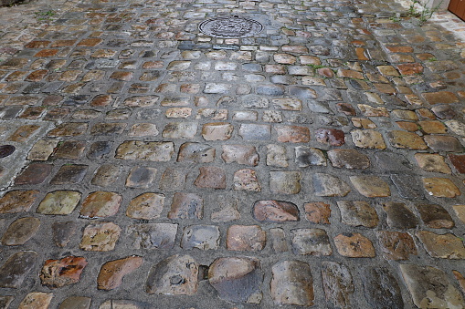Cobblestones wet by rain, cobbled street in the rain, city of Le Mans, department of Sarthe, France